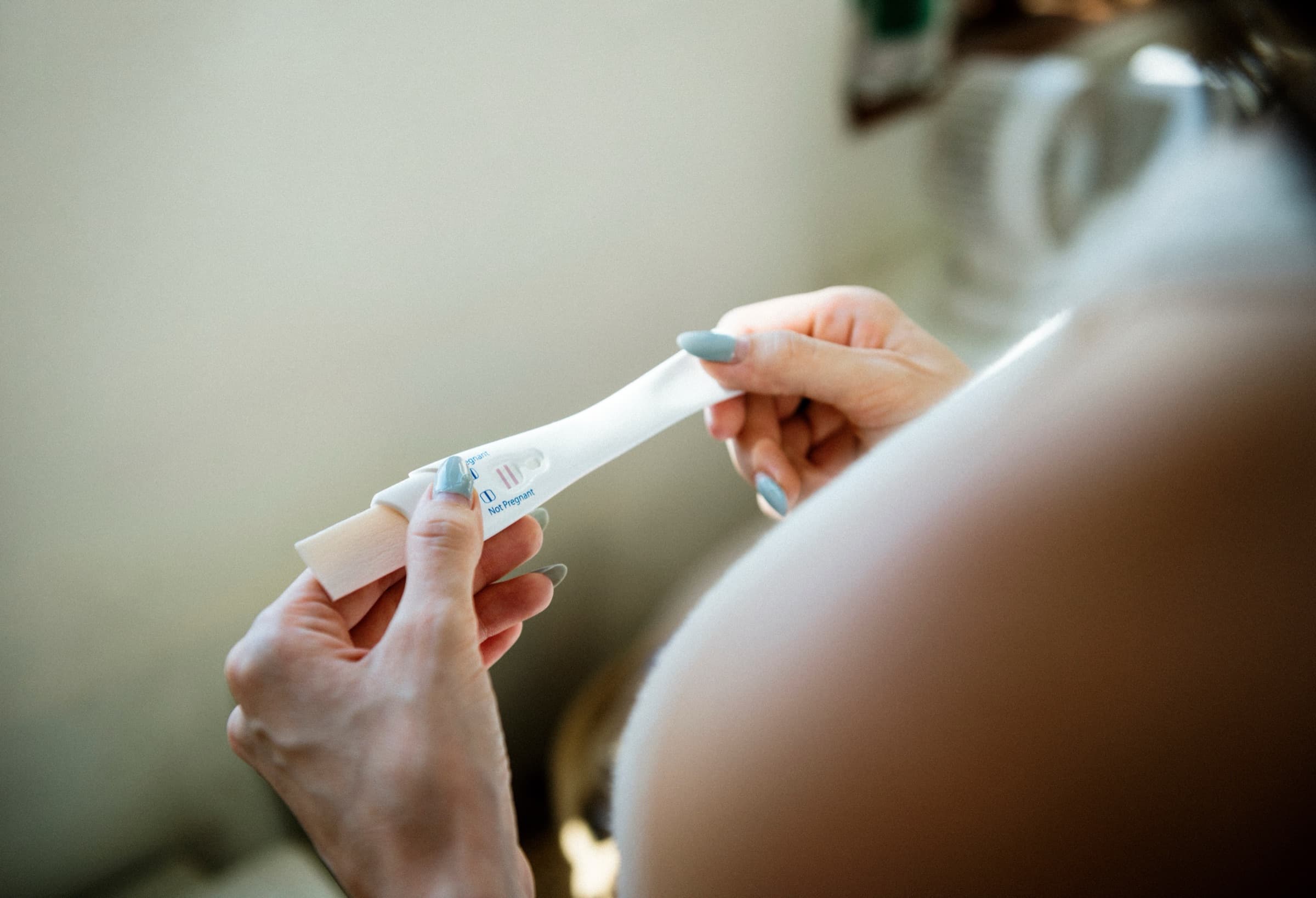 Hands holding a pregnancy test